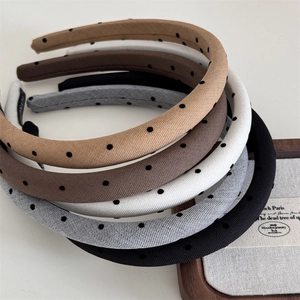 Set of five padded polka dot headbands in neutral colors with a handmade design