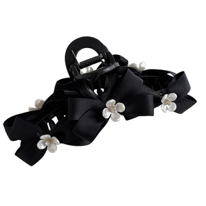 Elegant black ribbon bow hair claw clip with white floral details and sparkling rhinestones