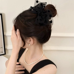 Elegant black polka dot mesh bow hair clip with French style worn on hair back