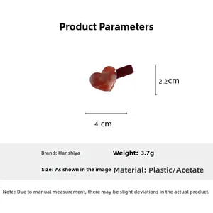 Macro detail of red marble acetate heart hair clip with dimensions 4cm x 2.2cm and weight 3.7g
