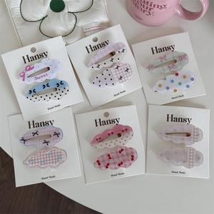 Set of cute polka dot and cloud shaped hair clips in various pastel colors and patterns