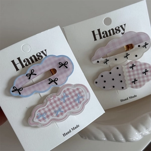 Detail of cloud-shaped hair clips with polka dots and bows on display cards