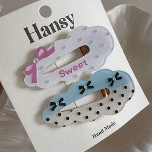 Detail of sweet cloud hair clips with heart sequins, polka dots and bowknot charms