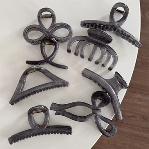 Set of 6 glittery star grey hair claws in various shapes for elegant hair styling
