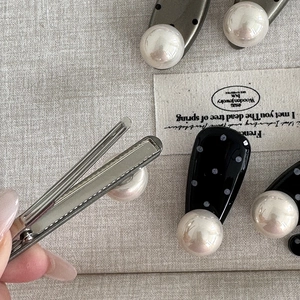 Elegant black polka dot duckbill hair clip with large pearl ornament for women's styling