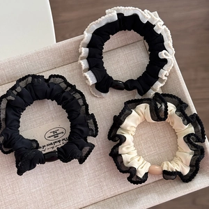 Three-piece set of elegant lace scrunchies in black and beige with oval decorative beads