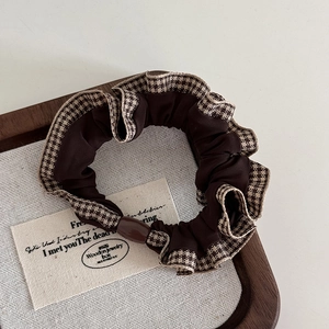Close-up of vintage brown scrunchie with houndstooth lace and round resin bead detail