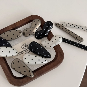 Retro polka dot hair clip set including heart and teardrop shapes in black and silver