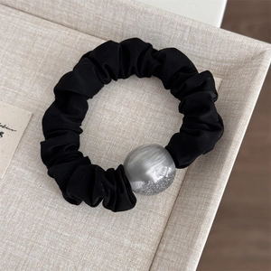 Detail of high-elasticity black hair tie with sparkling gray resin sphere ornament