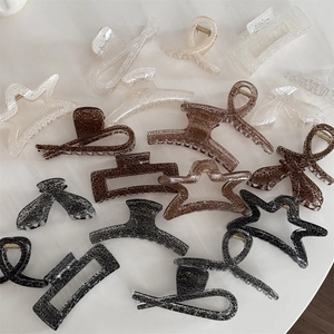 Close-up of assorted square and star hair claws with unique cracked marble patterns