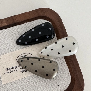 Close-up of three pieces polka dot waterdrop hair clips in black, white and grey colors