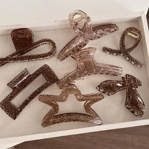 Detail showing vintage brown hair claws with ice-crack texture and star patterns