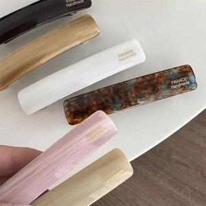 Detail view of the France Handmade gold stamp on cellulose acetate spring hair clips