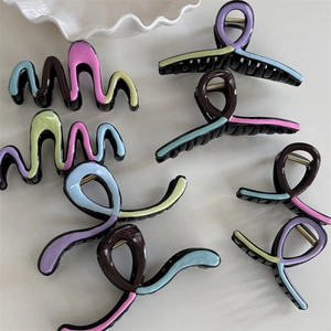 Detailed view of colorful wavy hair claw clips in morandi tones with glossy finish