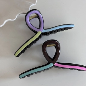 Close-up of colorful wave hair claws with durable golden metal springs and glossy finish