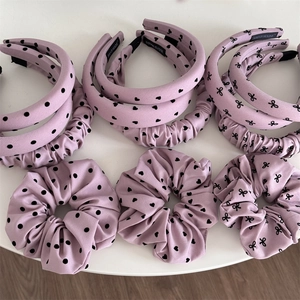 Détail d'un ensemble de serre-têtes et chouchous violets faits main avec pois et nœuds