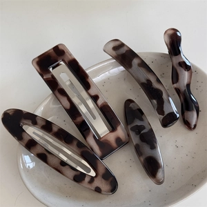 Close-up of tortoise shell pattern acetate hair clip set in various geometric shapes
