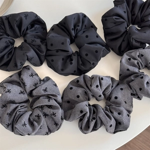 Set of black and grey polka dot scrunchies with heart patterns and bow embroidery