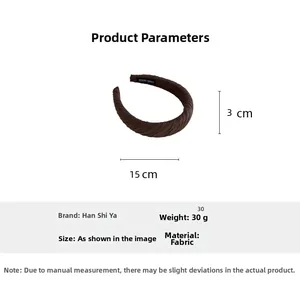 Detail of dark brown pleated fabric headband with 3cm width and handmade label