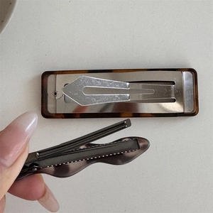 Detailed macro view showing the internal metal clip structure and tortoiseshell pattern