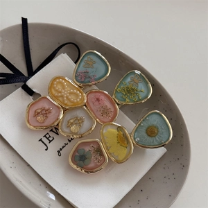 Floral resin hair clips with real dried flowers and pearl butterfly on white card