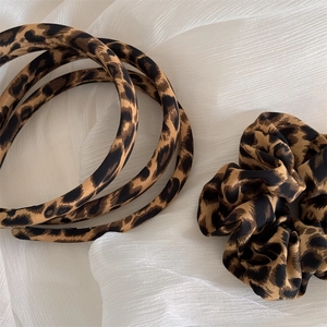 Detail of leopard print hair accessory set with fabric headbands and fluffy scrunchie