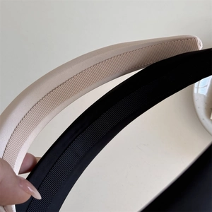 Detail shot of the ribbed texture and fabric wrapping on black and beige headbands