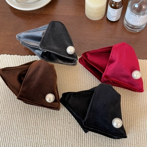 Detailed view of velvet triangular hair claws with large pearl accents in four warm colors