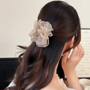 Elegant floral hair claw clip with pink organza lace petals on long dark hair accessory