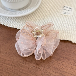 Detailed view of pink mesh tulle hair claw clip with delicate polka dot embroidery pattern