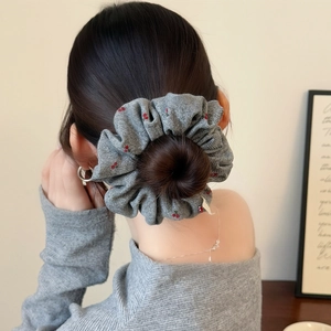 Detail of gray cherry print hair scrunchie shown in a stylish bun on a model's back
