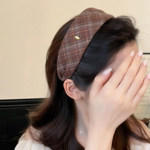 Maillard brown plaid wide headband with gold Love metal piece on female model side view