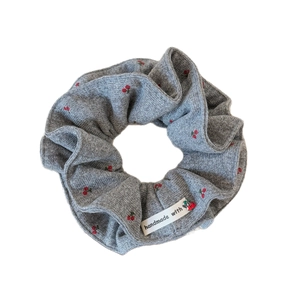 Elegant grey knitted hair scrunchie featuring cute red cherry patterns and handmade label