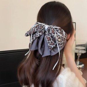 Elegant leopard print bow hair claw clip for women featuring premium double-layer ribbon