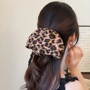 Retro leopard print bow hair clip for women with elegant ponytail hairstyle back view