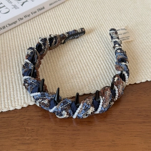 Detail of hand-woven knitted headband with pearls, non-slip teeth and hand-made text