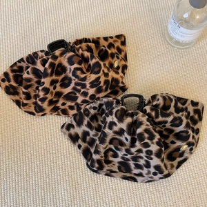 Set of two leopard print claw clips in warm coffee and cool grey-brown fabric tones