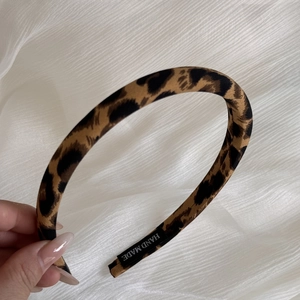 Classic leopard print wide headband in brown and black tones with handmade label