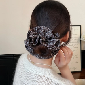 Vintage dark brown floral scrunchie hair tie with white branch patterns on soft fabric