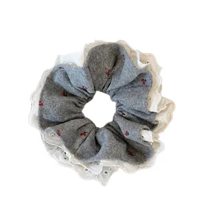 Gray knitted scrunchie with cherry print and white lace trim for ponytails