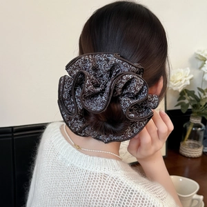 Elegant floral oversized scrunchie worn on hair bun with vintage aesthetic and soft fabric
