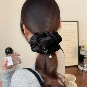 Elegant black velvet scrunchie with silver texture and pearl charm for hairstyles