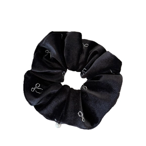 Elegant black velvet scrunchie with silver bow patterns and a delicate white pearl pendant