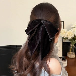 Elegant large black velvet bow hair clip for ponytail styling with luxury minimalist design