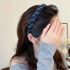 Vintage navy blue geometric pattern headband on model for elegant high cranial top hairstyle