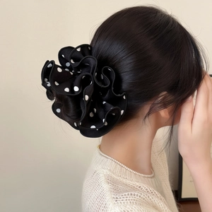 Polka dot hair scrunchie shown in a sophisticated updo for a stylish Korean hairstyle