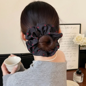 Denim fabric scrunchie with red polka dots shown on a model for a stylish ponytail look
