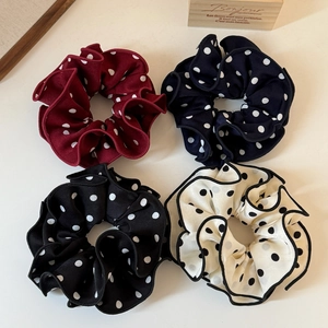 Set of four polka dot scrunchies in burgundy navy black and cream with ruffled edges