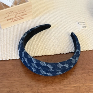 Close-up of vintage navy blue checkered wide headband with soft fabric texture
