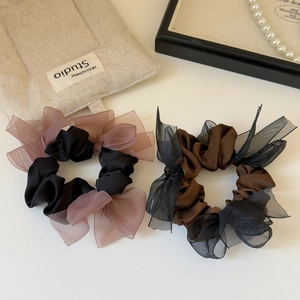 Elegant satin and organza bow scrunchies set in black and coffee colors on a white background